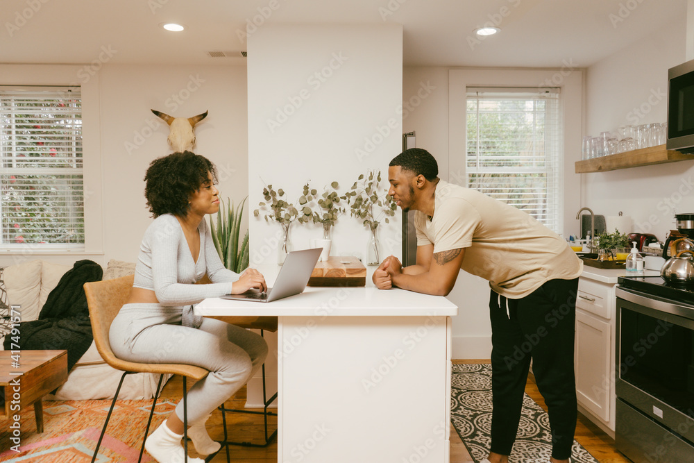 Cozy and comfy Black couple having conversation in kitchen