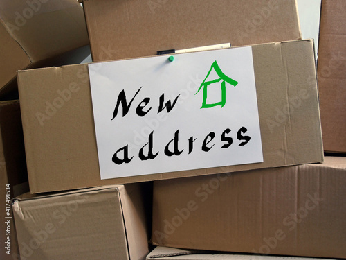 moving boxes and a sheet of paper with the inscription 