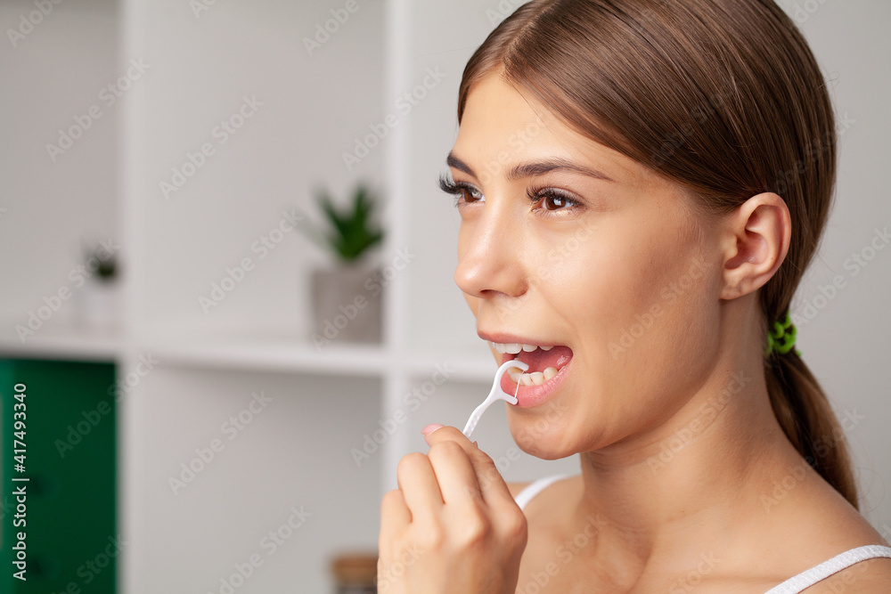 Oral hygiene and health care, smiling women use dental floss white healthy teeth. Oral hygiene and health care, smiling women use dental floss white healthy teeth.