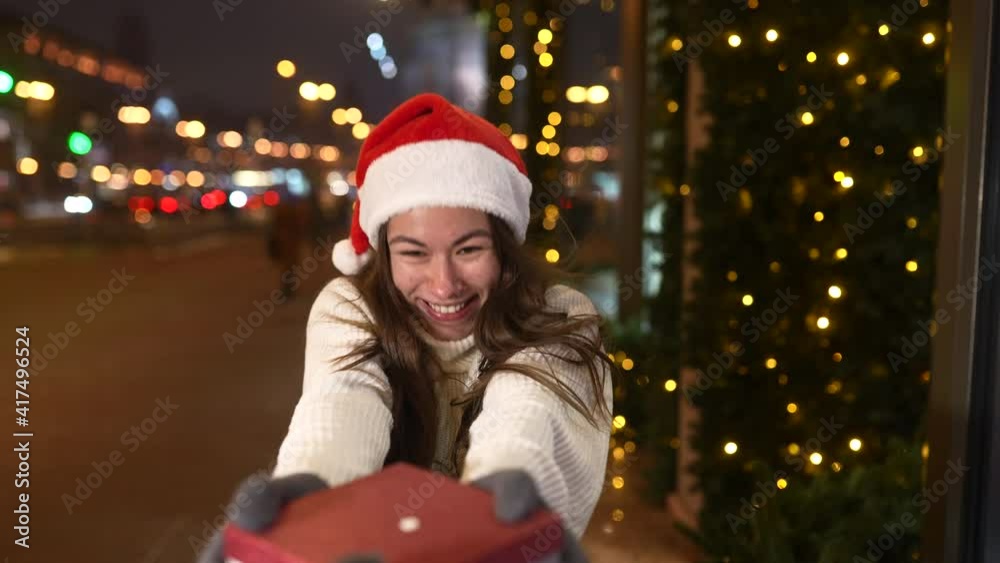 Young woman giving box for you outdoor. Gift exchange concept. Young woman giving box for you outdoor. Gift exchange concept.
