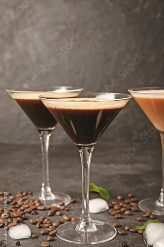 Glasses of coffee martini on dark background