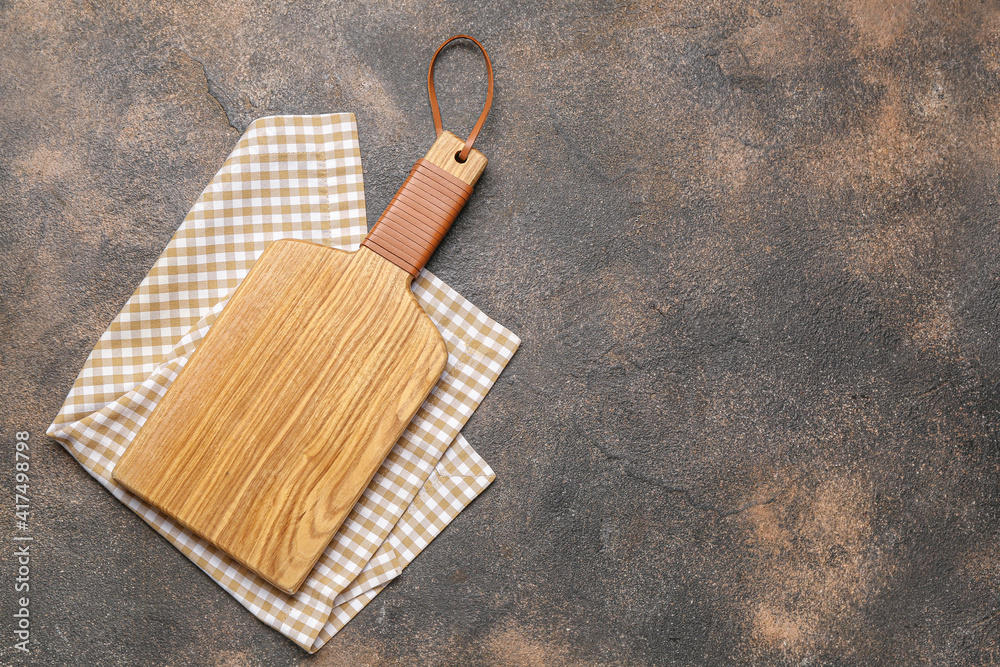 Fototapeta premium Wooden cutting board on grunge background