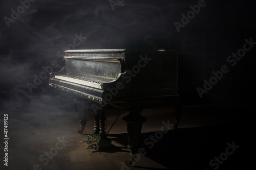 Old grand piano on the dark stage © AndrzejBoPhoto