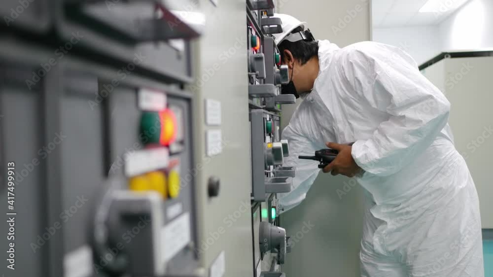 A man wearing chemical protection suit and working in Electrical substation Clean room, At the time of the COVID-19 outbreak A man wearing chemical protection suit and working in Electrical substation Clean room, At the time of the COVID-19 outbreak
