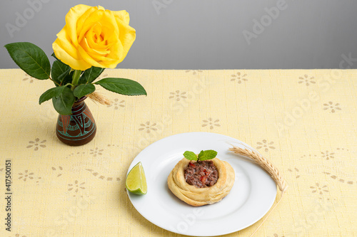 open puff pastry meat puffs on a white plate