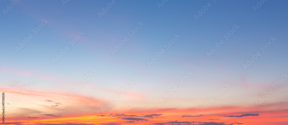 Beautiful sky painted by the sun leaving bright golden shades.Dense clouds in twilight sky in winter evening.Image of cloud sky on evening time.Evening sky scene with golden light from the setting sun