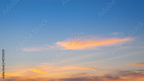 Beautiful sky painted by the sun leaving bright golden shades.Dense clouds in twilight sky in winter evening.Image of cloud sky on evening time.Evening sky scene with golden light from the setting sun