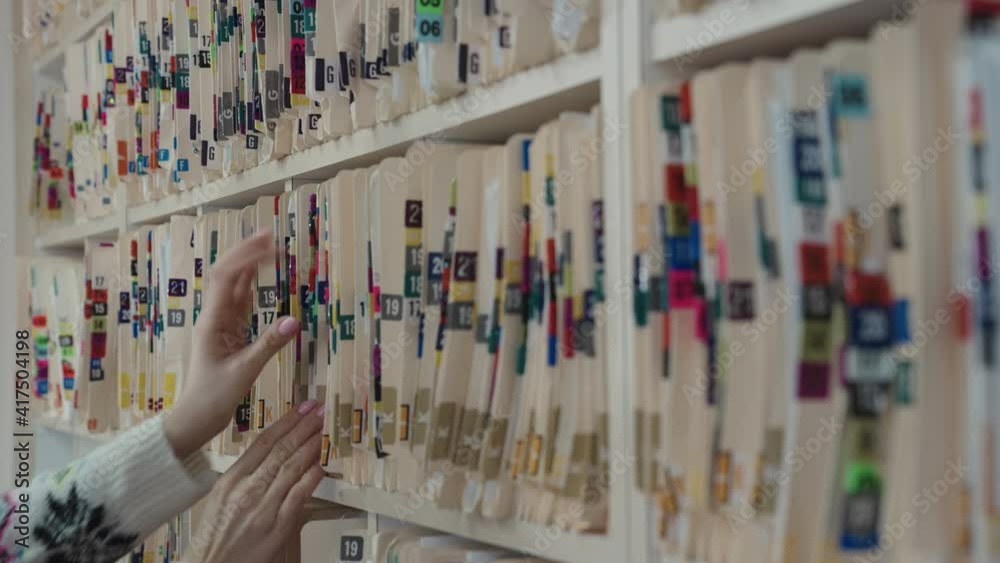 Doctor in Hospital Office Open Medical Archive and Search Medical Documents
