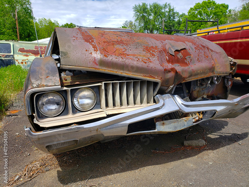 rusty wrecked forgotten car in a junkyard