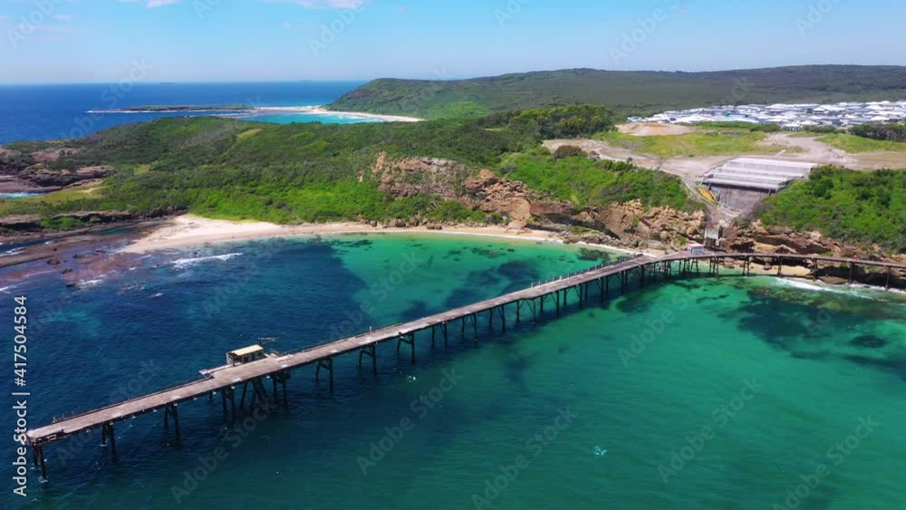 Beautiful pier on Australian coast, Catherine Hill Bay, aerial view Beautiful pier on Australian coast, Catherine Hill Bay, aerial view