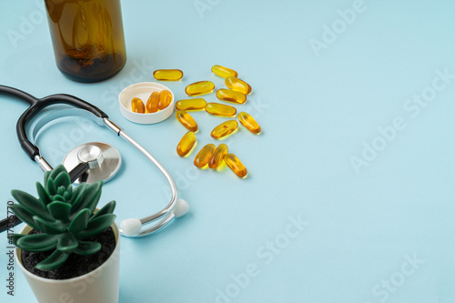 Fish oil tablet on a blue background with a copy space. Medical and health care concept.