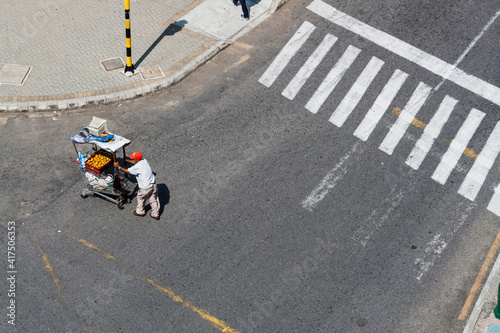 vendor with fruit cart at vehicular intersection photo