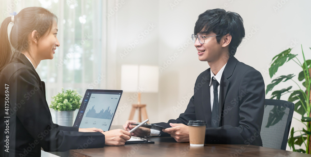 Teamwork Brainstorming Meeting and new startup project in the workplace, Smily Asian businesspeople working on laptop with graph documents. Teamwork Brainstorming Meeting and new startup project in the workplace, Smily Asian businesspeople working on laptop with graph documents.