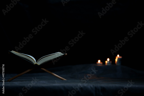 Quran in the mosque - open for prayers The black background of the Muslims around the world placed on a wooden board Quran in the mosque - open for 