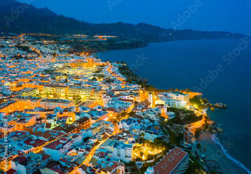 Fototapeta Naklejka Na Ścianę i Meble -  Aerial view of illuminated Nerja city at Mediterranean coast, Costa del Sol, Spain