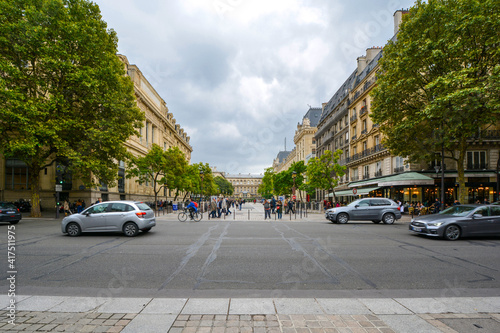 Fototapeta Naklejka Na Ścianę i Meble -  A street scene on the Ile de la Cite in the fourth arrondisement with the Palais du Justice visible on the right side of the pedestrian walkway