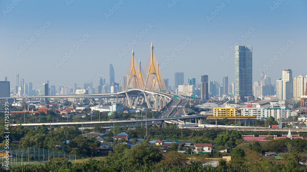 Fototapeta premium The landscape of the Chao Phraya River and the Bhumibol Bridge against the backdrop of Bangkok's skyscrapers