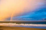 Rainbow over the ocean at sunset