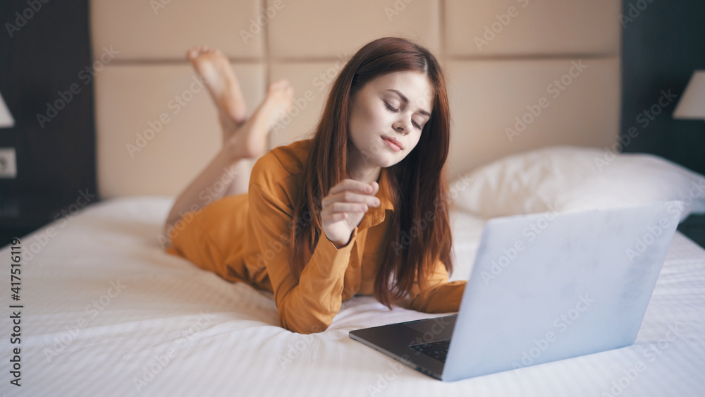 woman with laptop lies on bed internet communication freelance woman with laptop lies on bed internet communication freelance