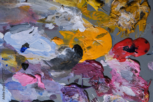 Background of an artist's palette with mixed dried acrylic paints. An abstract artwork.  photo