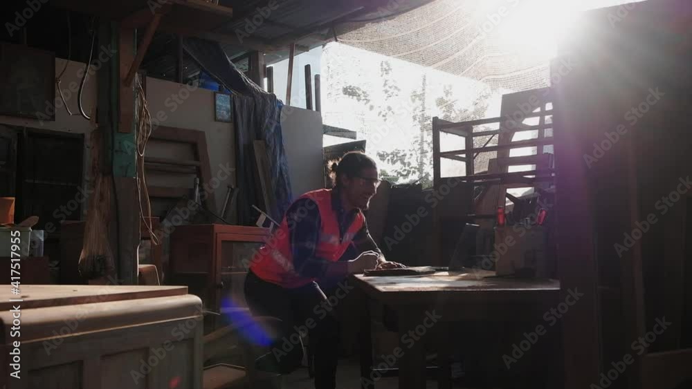 A young carpenter is working to order in his own wood factory. With peace of mind by using hand tools including saws, wood planers, hammers, and more. A young carpenter is working to order in his own wood factory. With peace of mind by using hand tools including saws, wood planers, hammers, and more.