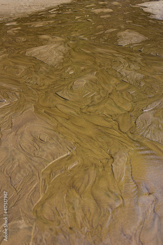 The delta of a creek emptying into Smuggler Cove on the Oregon coast creates tide pools on Short Sand Beach photo