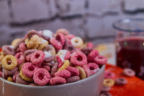 bad breakfast of colorful cereals full of sugar with red fruit juice