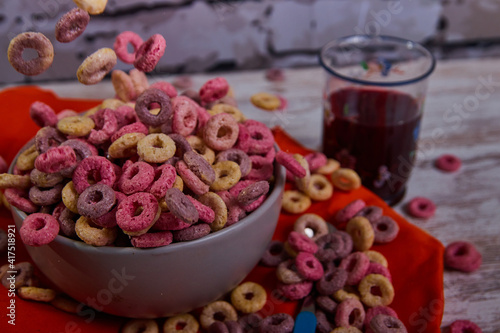 bad breakfast of colorful cereals full of sugar with red fruit juice