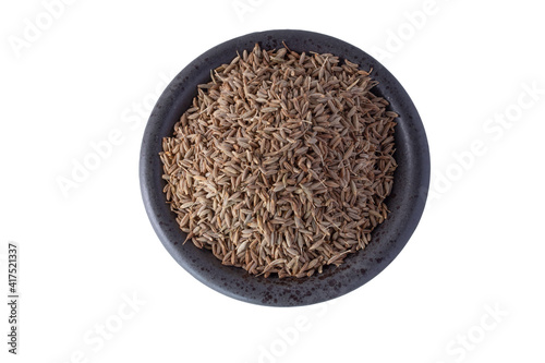 Black cumin in the cup on a white background