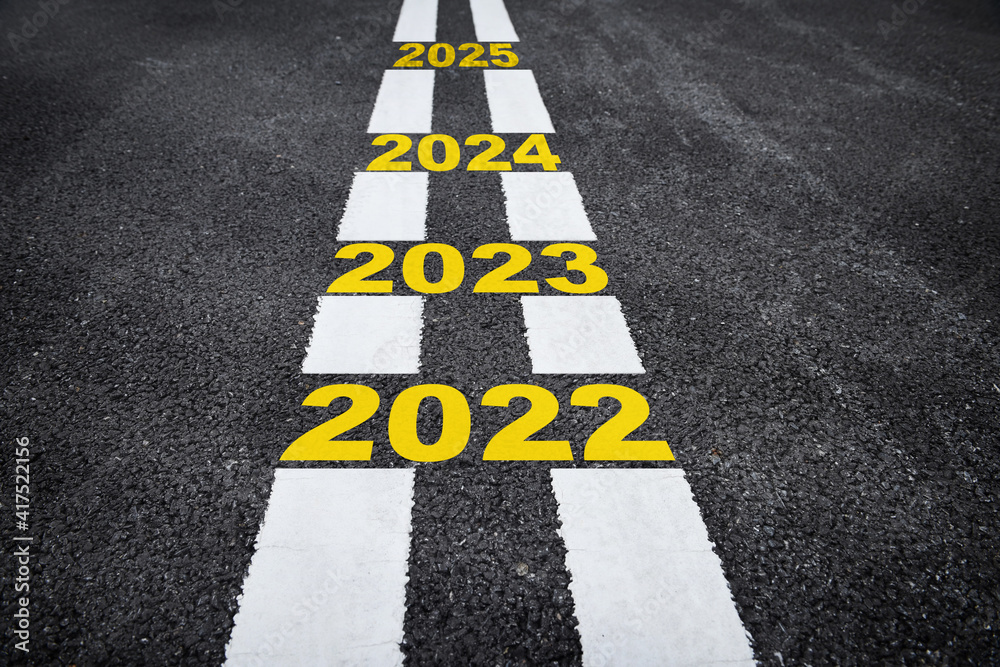 Number of 2022 to 2025 on asphalt road surface with marking lines, happy new year concept