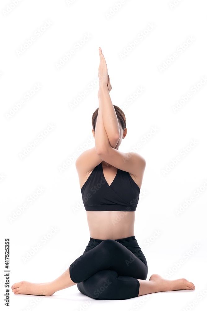 Beautiful sporty woman doing advanced yoga practice on white bac