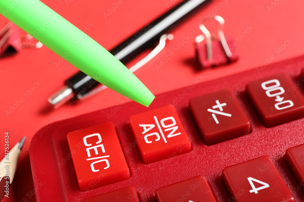 Modern calculator and pen, closeup