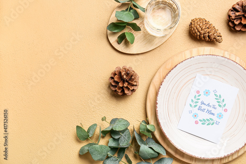 Beautiful table setting for Mother's Day on color background