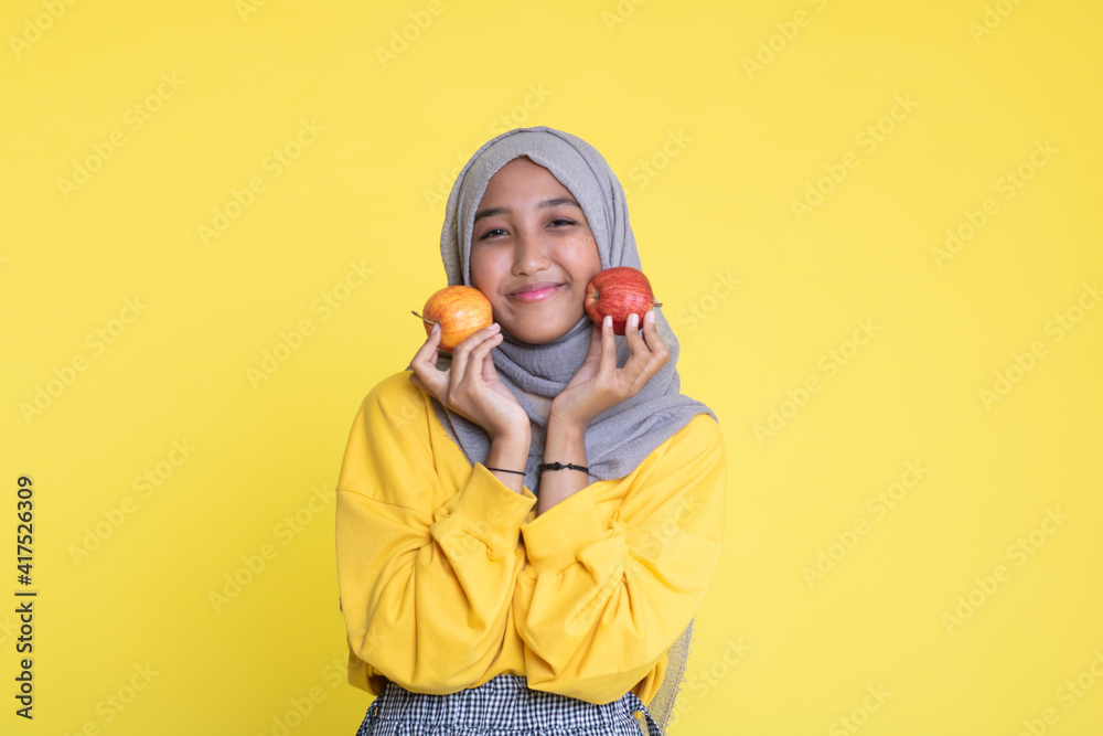 beautiful girl with red apple on yellow background beautiful girl with red apple on yellow background