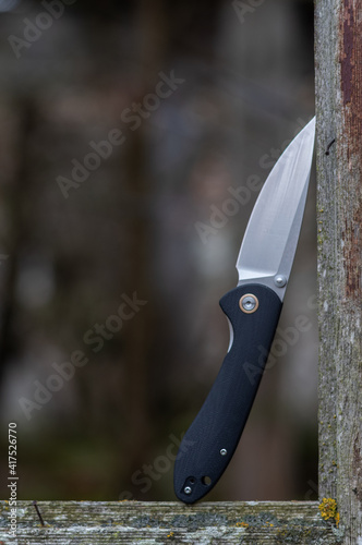 Pocket knife for daily carry. Elegant knife design with black handle. photo