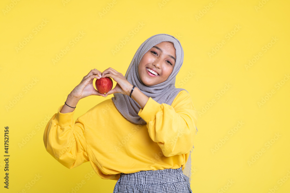 beautiful girl with red apple on yellow background beautiful girl with red apple on yellow background