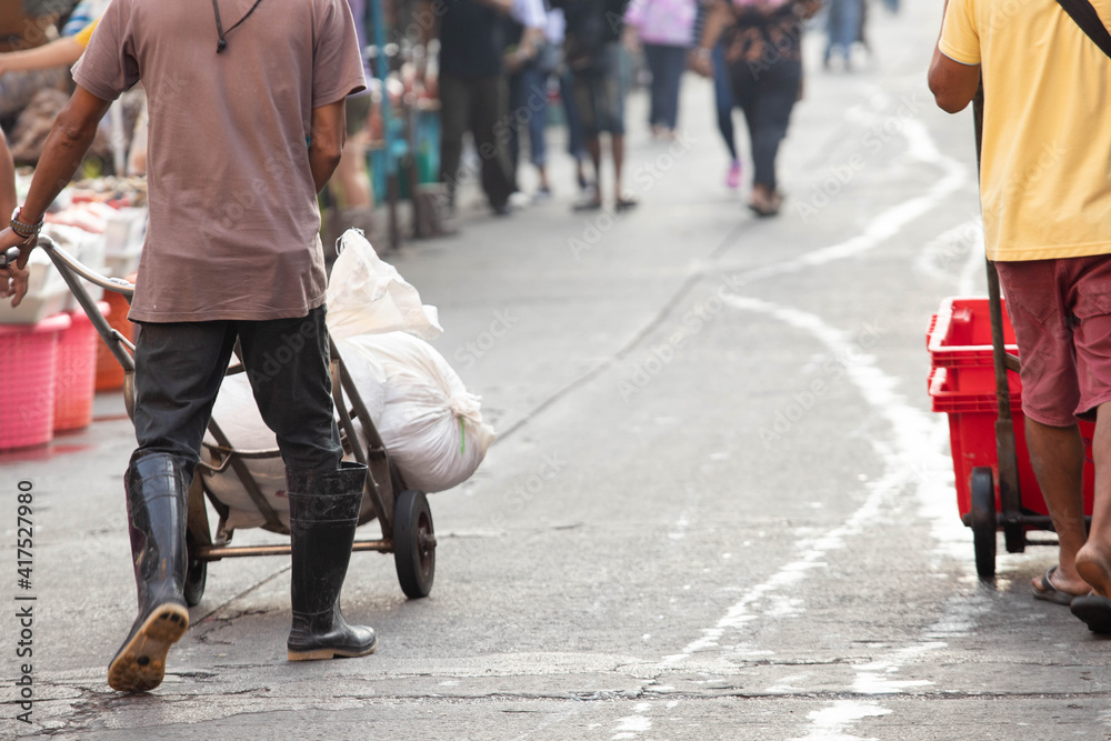 Workers deliver ice to customers in the wet market. Workers deliver ice to customers in the wet market.