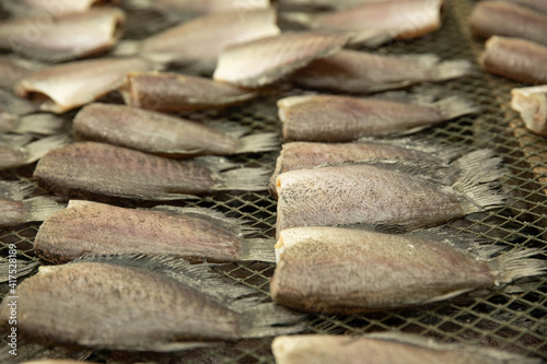 The gourami is cut off its head and placed in a basket.