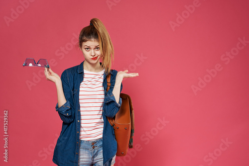 Pretty woman fashionable clothes studio backpack cropped view pink background