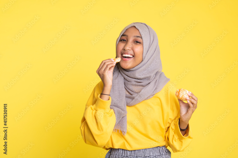 woman with orange on yellow background.
