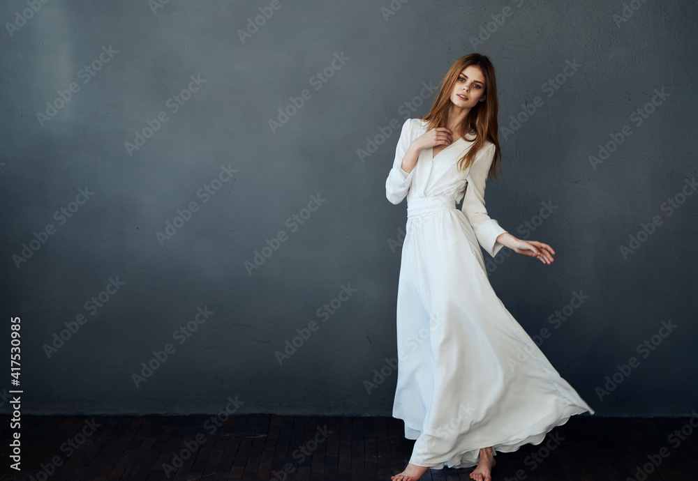 Pretty woman white dress studio performing dance gray background model Pretty woman white dress studio performing dance gray background model