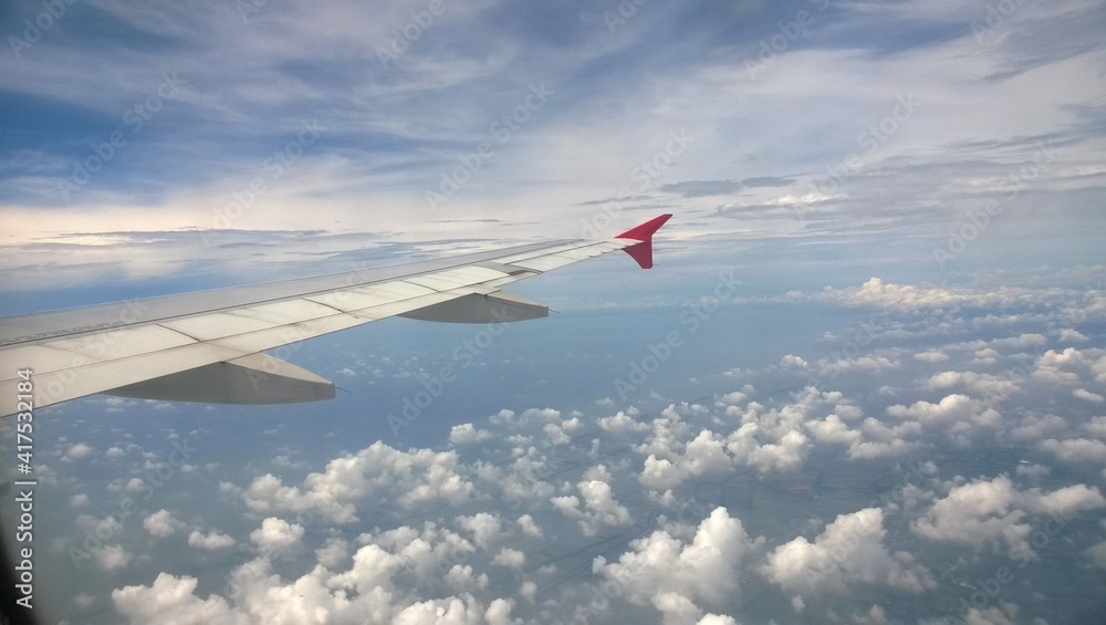 the airplane wing with blue sky and cloud , View from airplane window the airplane wing with blue sky and cloud , View from airplane window