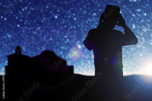Silhouette of Muslim man in praying position (salat)