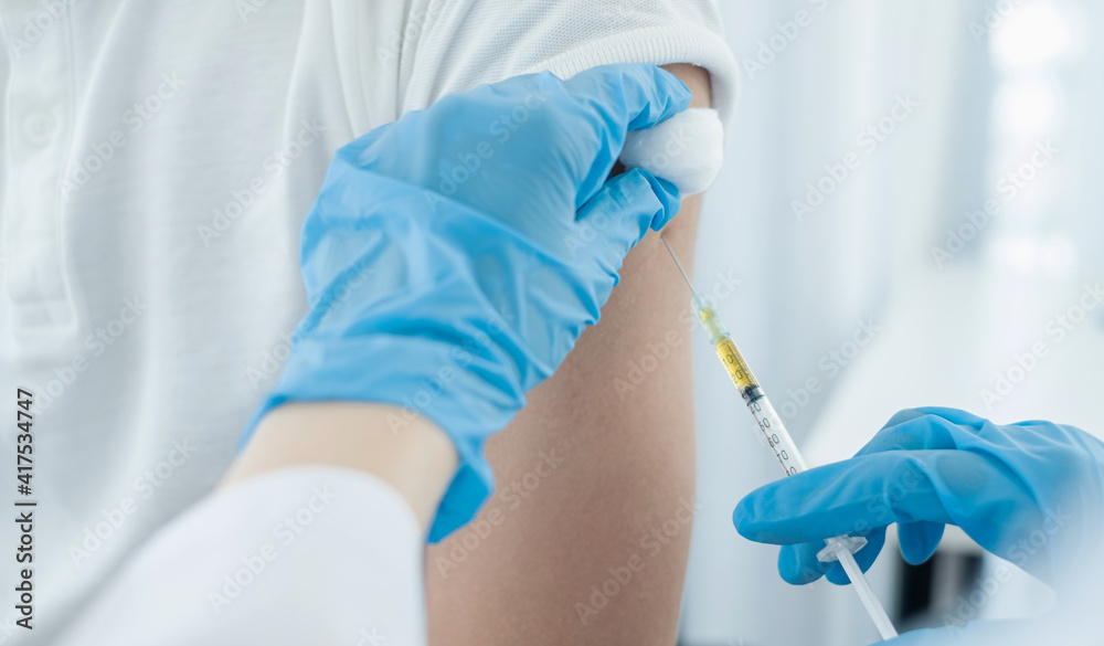Female doctors vaccinated with syringes to prevent epidemics at hospitals, health care, and medical concepts Female doctors vaccinated with syringes to prevent epidemics at hospitals, health care, and medical concepts
