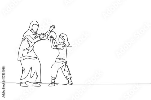 Fototapeta Naklejka Na Ścianę i Meble -  One continuous line drawing of young Islamic mom playing basketball with daughter at outfield park. Happy Arabian muslim parenting family concept. Dynamic single line draw design vector illustration