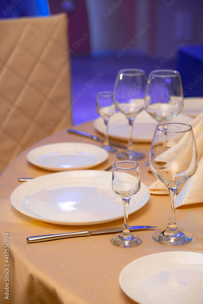 Fototapeta premium Elegant table setting for a festive dinner in the restaurant