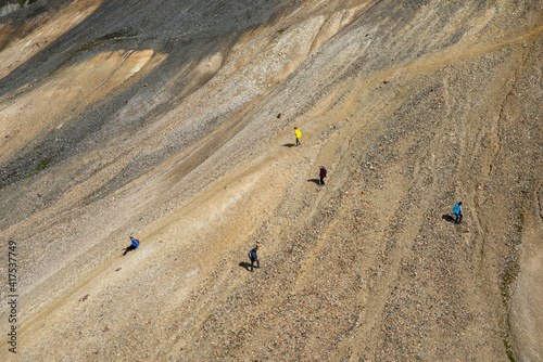  Hikers in volcanic mountains of Landmannalaugar in Fjallabak Nature Reserve. Iceland