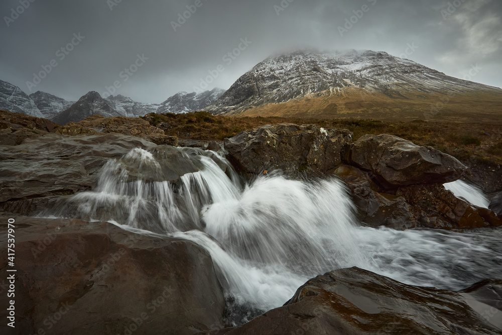 long silky waterfall between stones and rocks. travel, tourism, adventure, mountaineer concept- Fairy Pools - Skye Island - Scotland - Uk