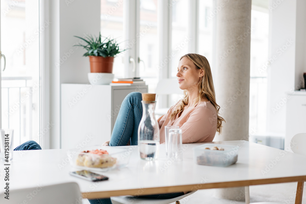 Relaxed contented young woman taking a break at the office Relaxed contented young woman taking a break at the office