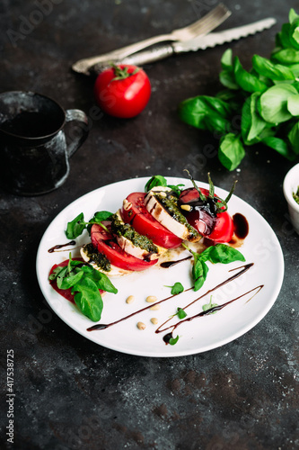 Caprese salad. Tomatoes  mozzarella  basil  pesto  balsamic sauce